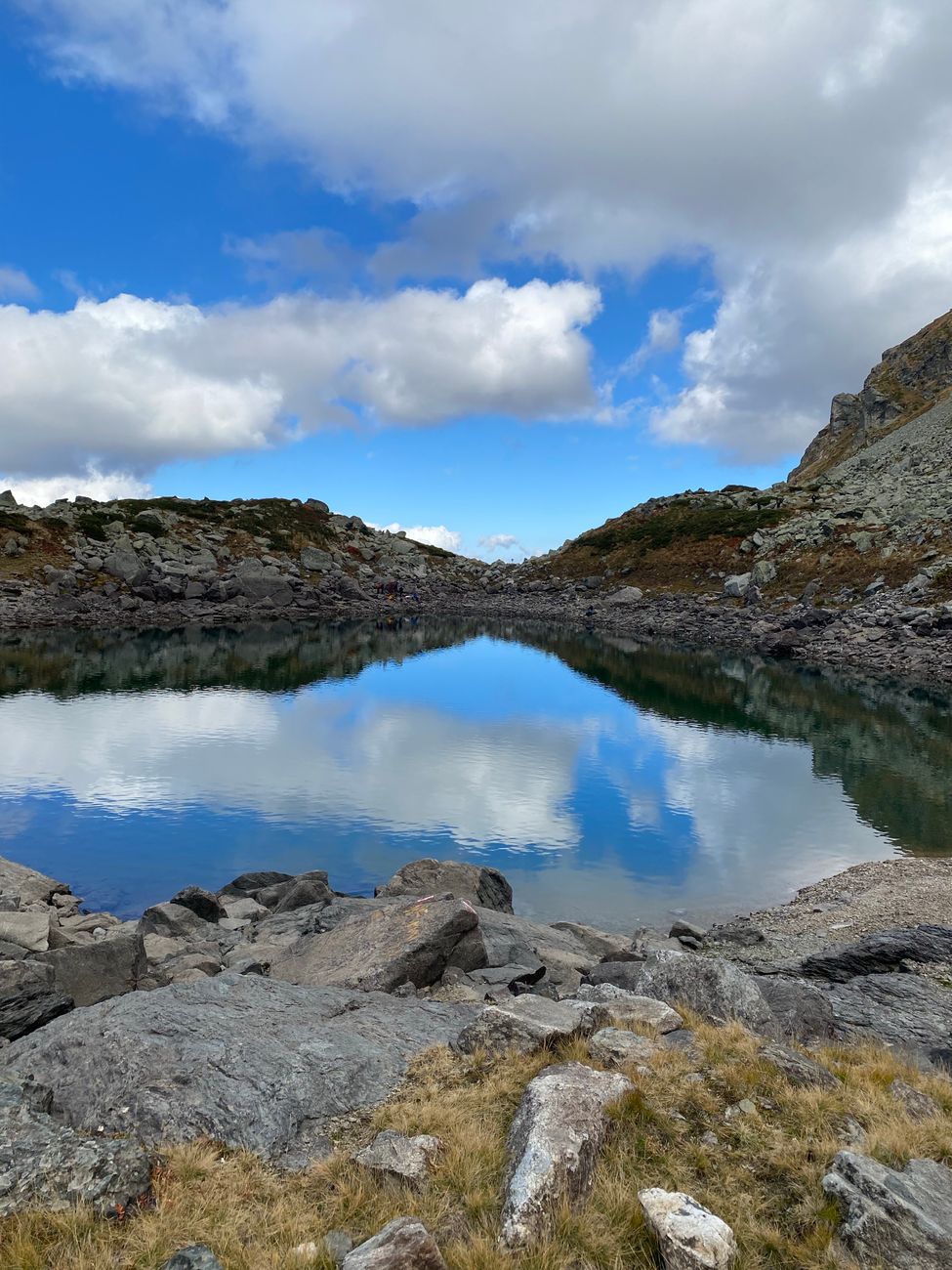 Wild alpine lake crossing hike
